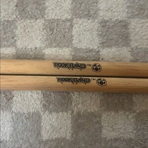 pair of Rock Band brand drumsticks designed for use with the Rock Band
